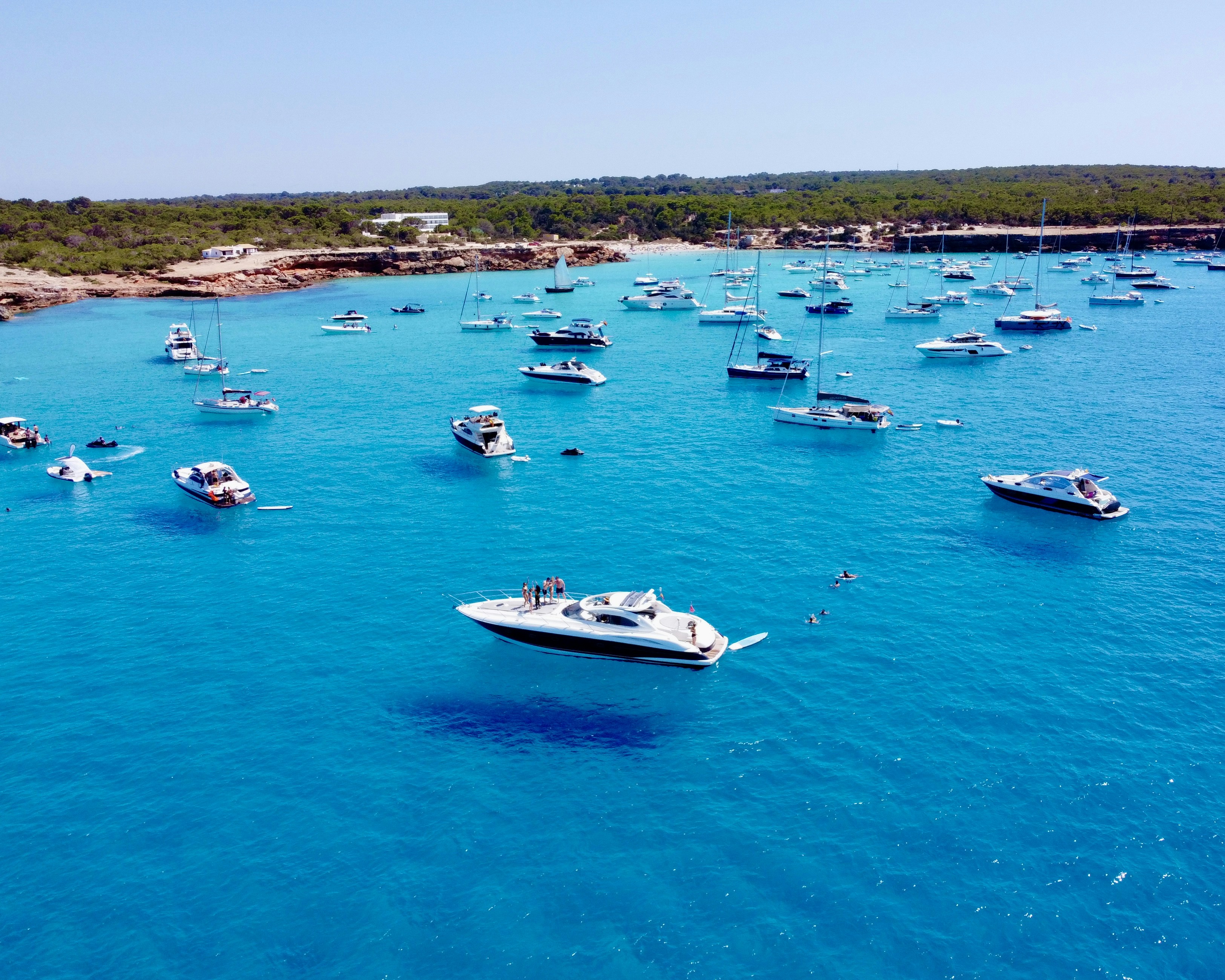 a group of boats floating on top of a body of water