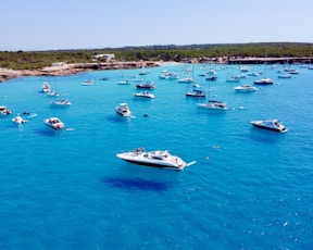 a group of boats floating on top of a body of water