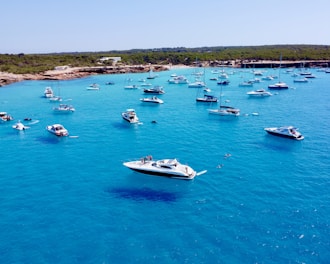 a group of boats floating on top of a body of water