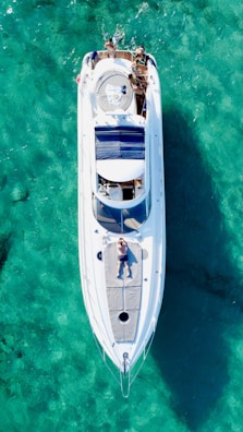 a white boat floating on top of a body of water