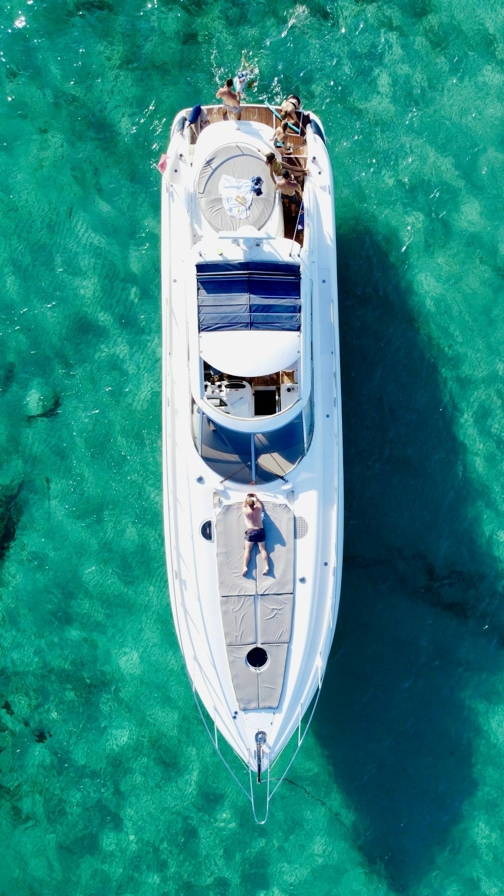 a white boat floating on top of a body of water