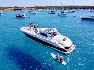 a group of people standing on a boat in the water