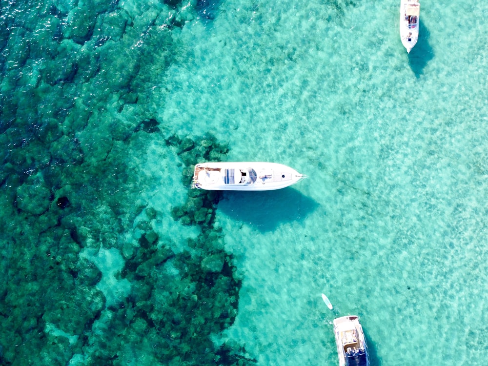 a couple of boats floating on top of a body of water