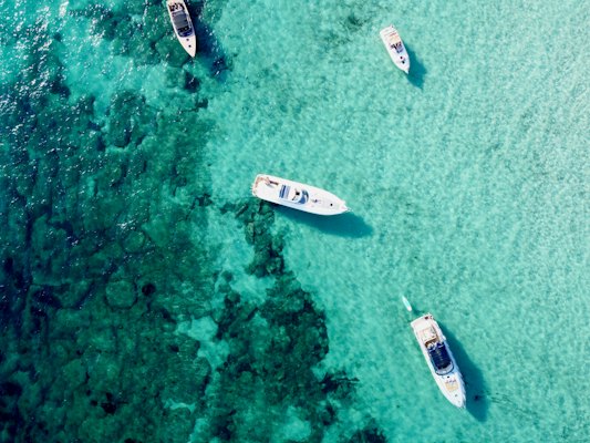 A group of boats floating on top of a body of water — Ibiza, Spain