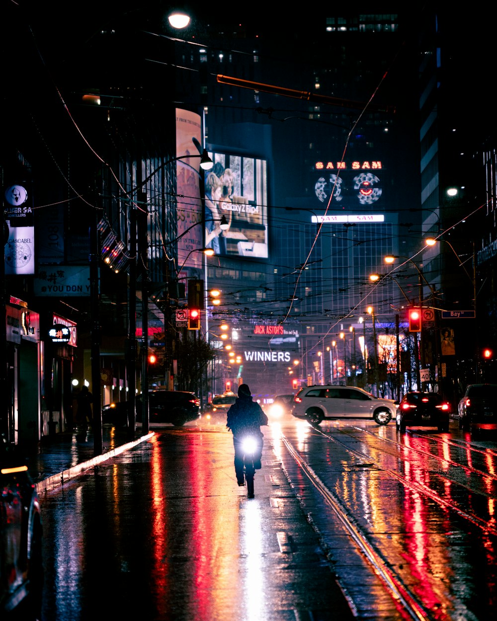 a person walking down a street at night