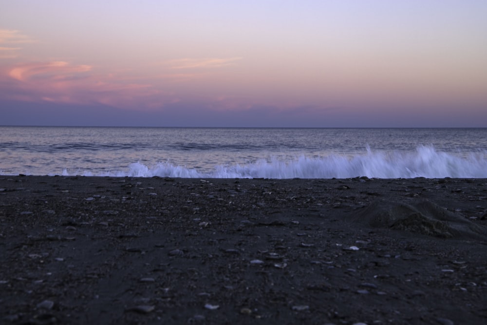 a beach with waves coming in to shore