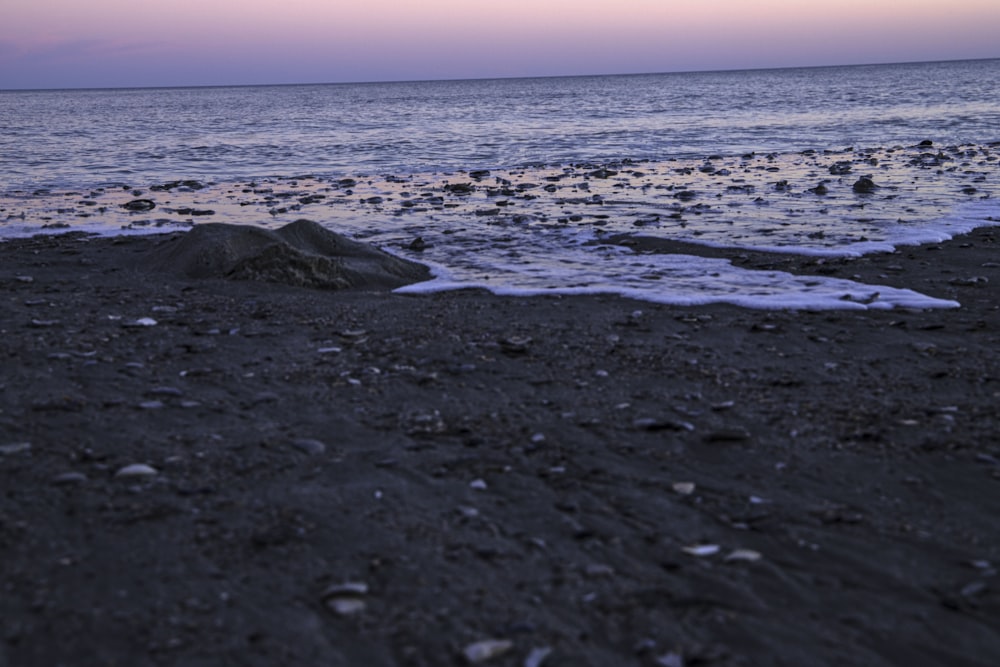 a view of the ocean from a rocky beach