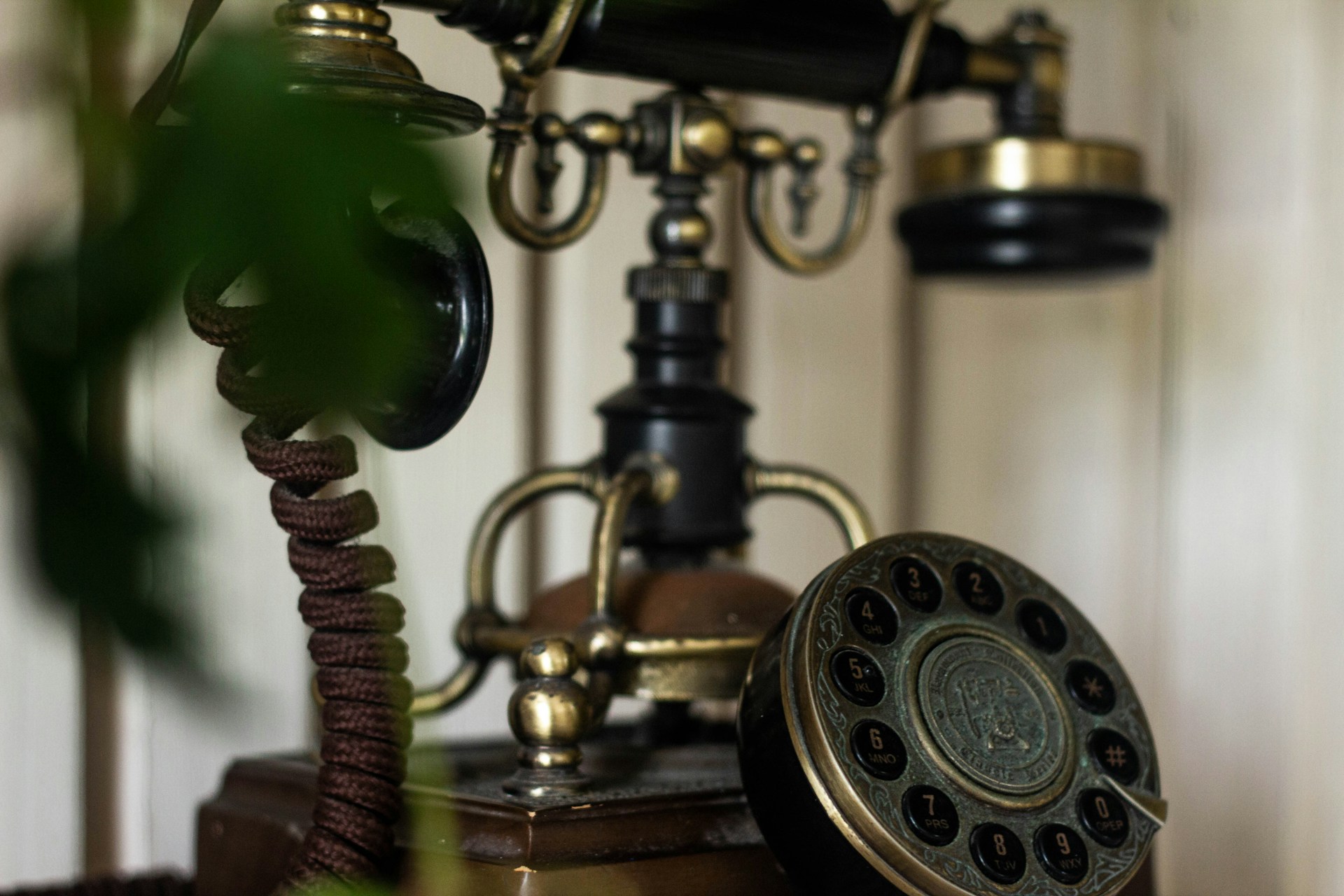 an old - fashioned phone with a cord attached to it