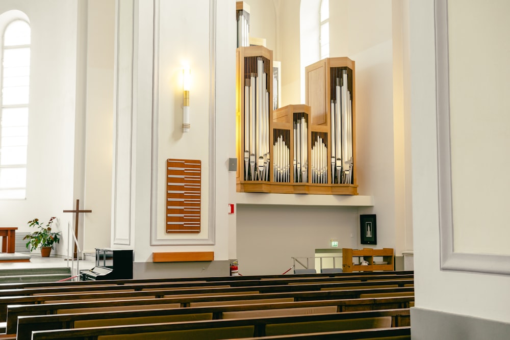 a church filled with pews and a pipe organ