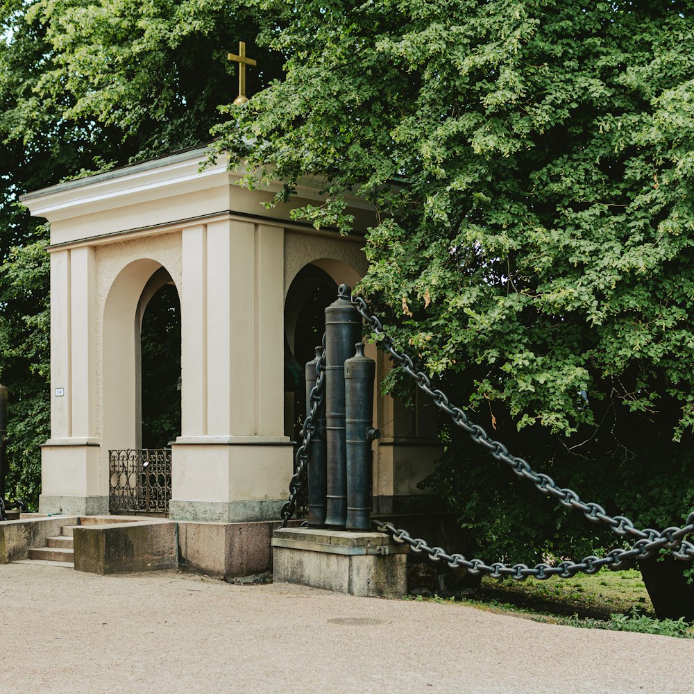 a small white building with a cross on top of it