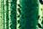 Green metallic panels with abstract cut-out patterns create intricate shadows and light effects.