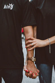 a couple holding hands while standing next to each other