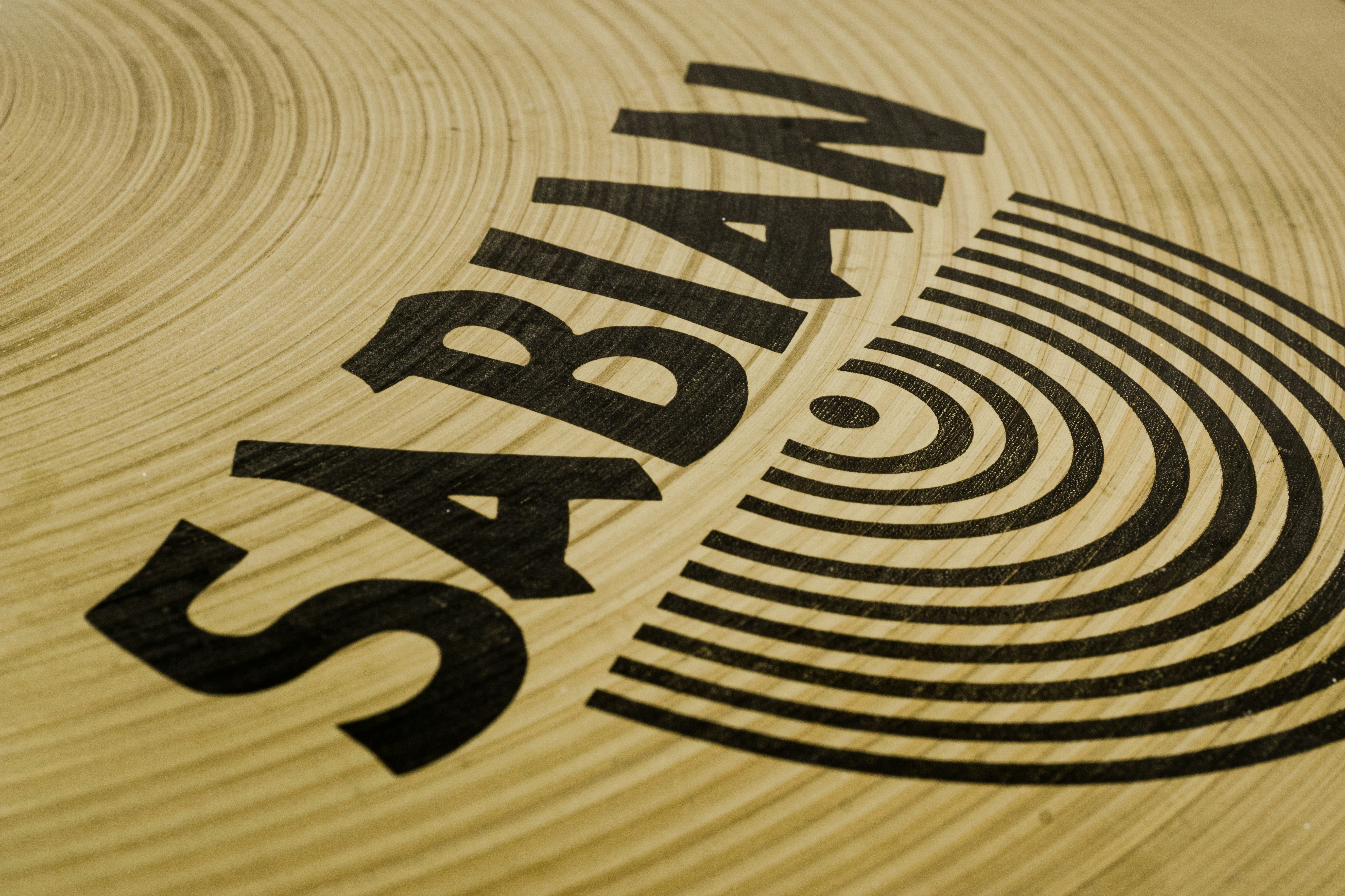 a close up of a wooden surface with a logo on it
