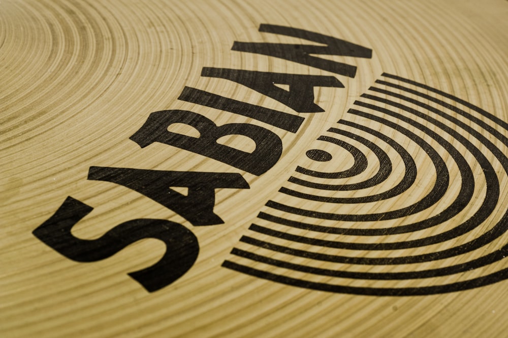 a close up of a wooden surface with a logo on it