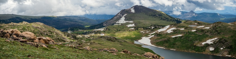 a mountain range with a lake in the foreground