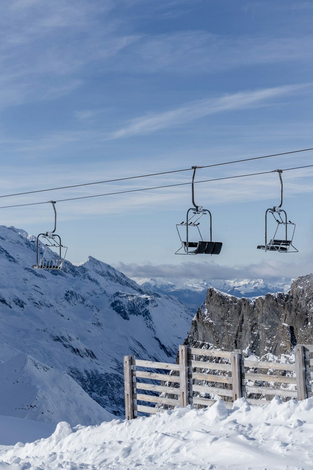 a ski lift going up a snowy mountain