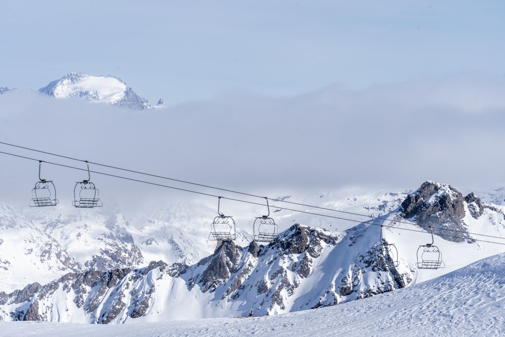 a ski lift going up a snowy mountain