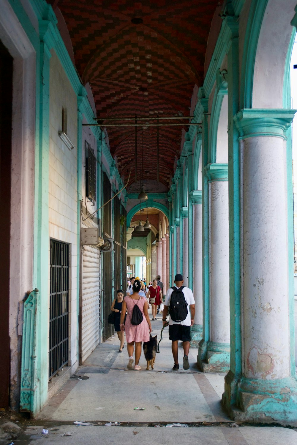 a group of people walking down a long hallway