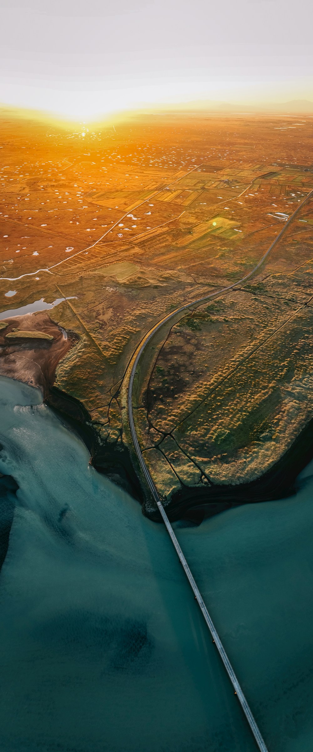 an aerial view of a river and a highway