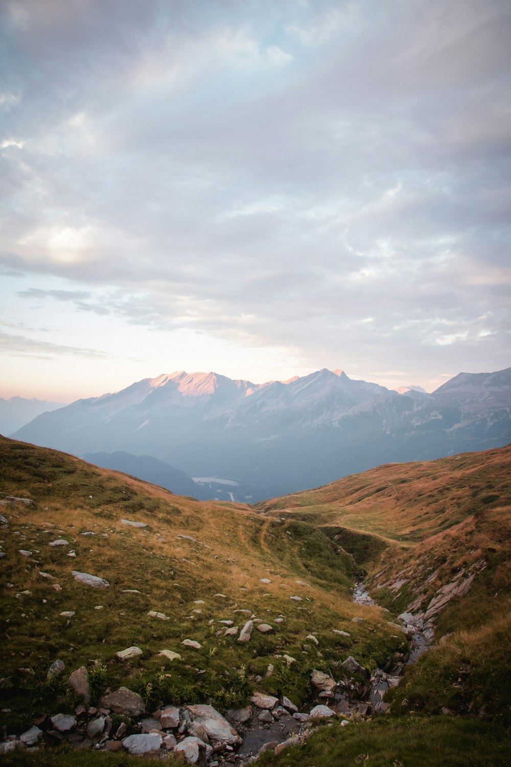 a mountain range with a stream running through it