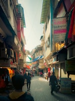 A vibrant street scene in Aden showing local market activity under bright sunlight.