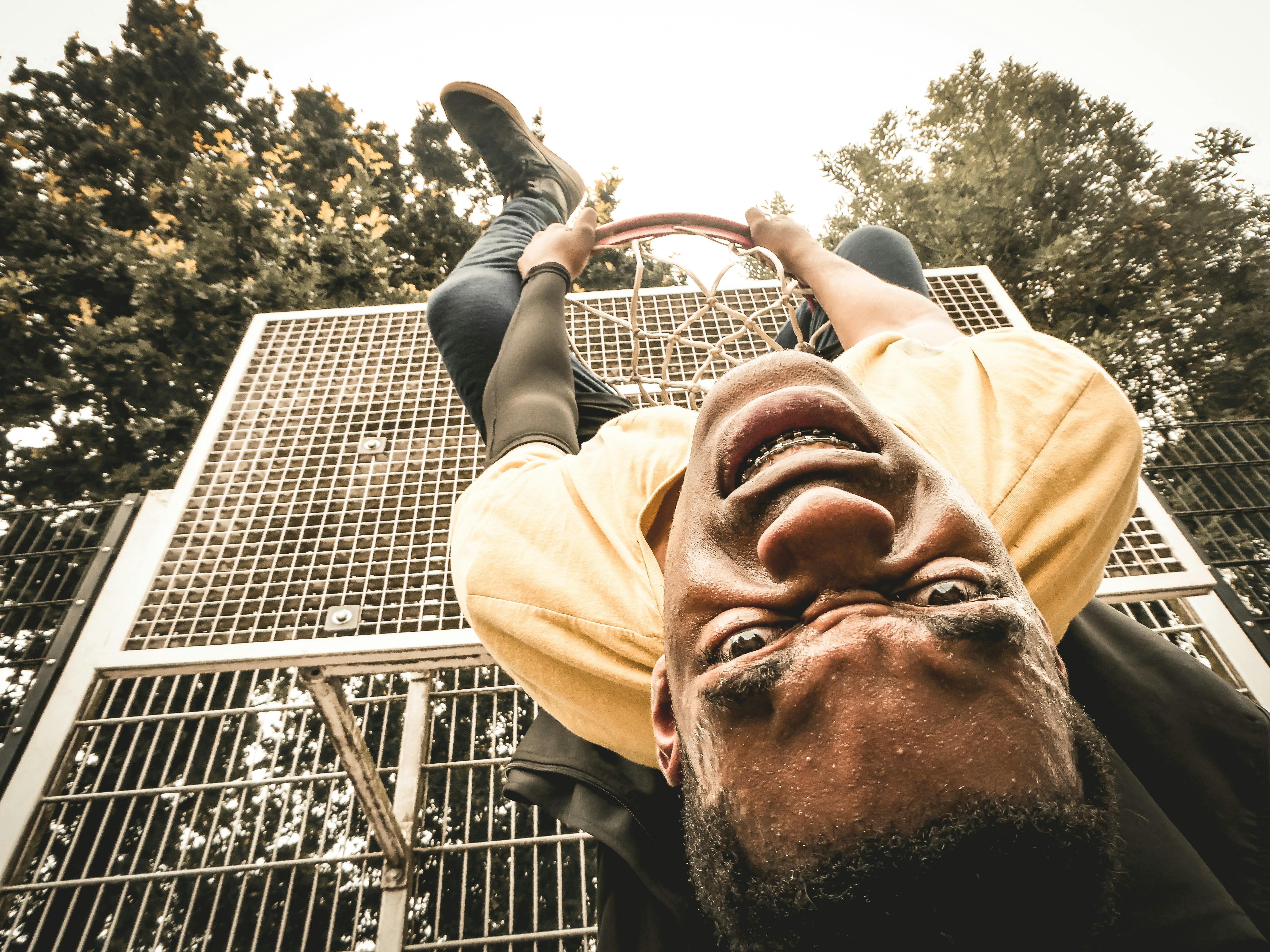 a man is upside down on a metal structure