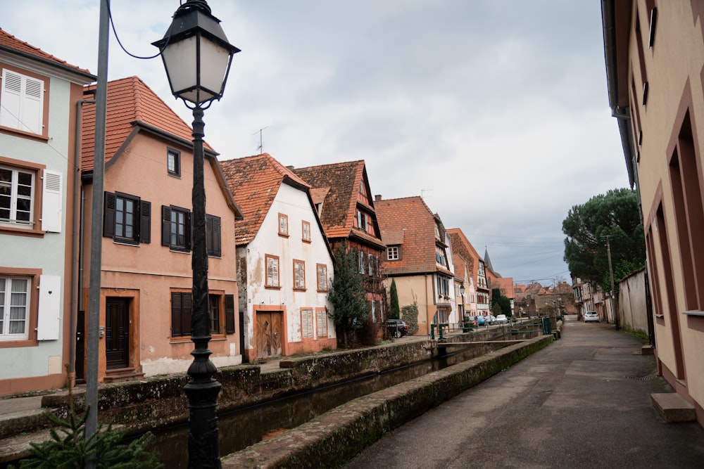 a row of houses on a street with a lamp post