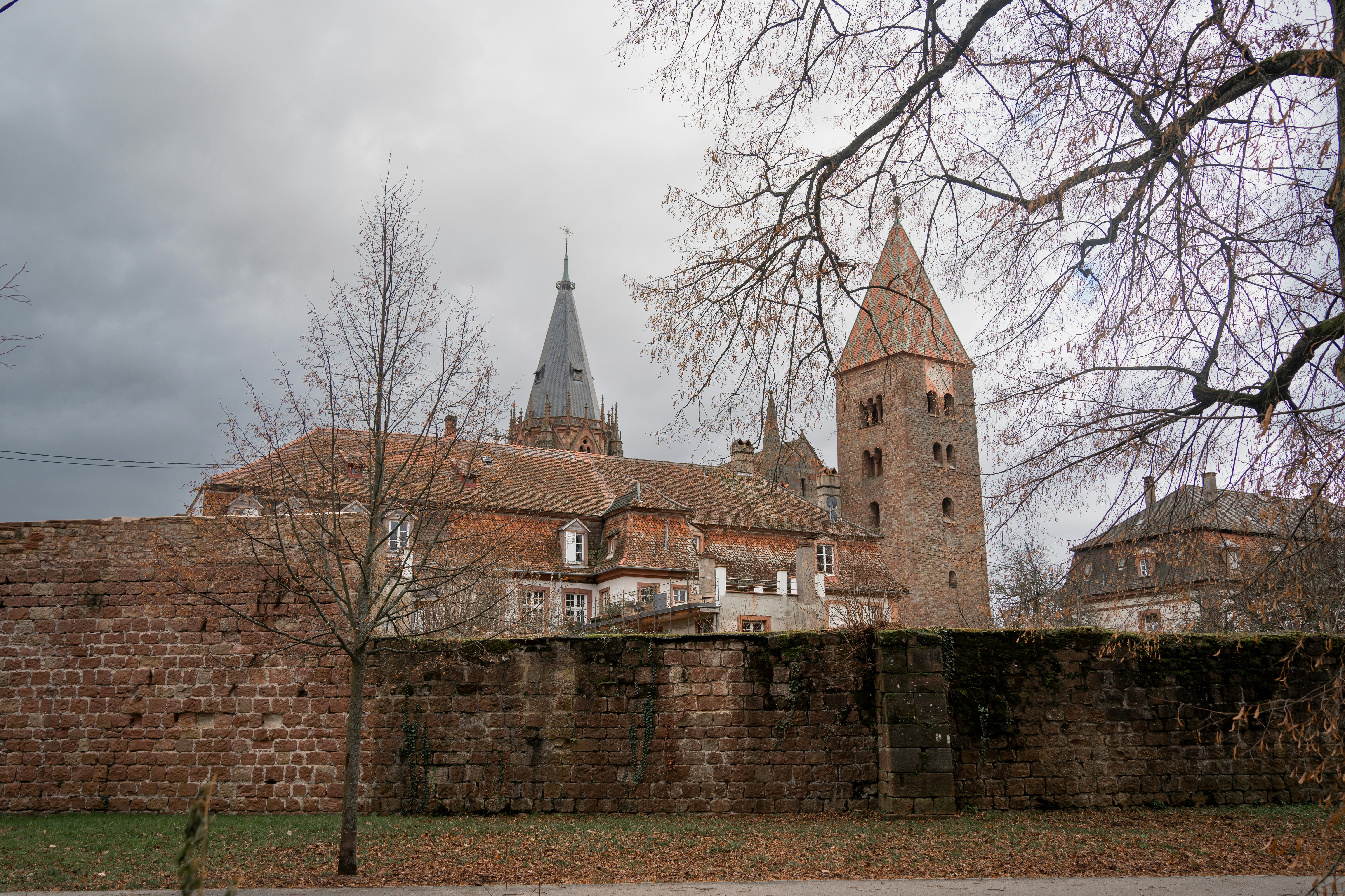 a large brick building with a steeple in the background