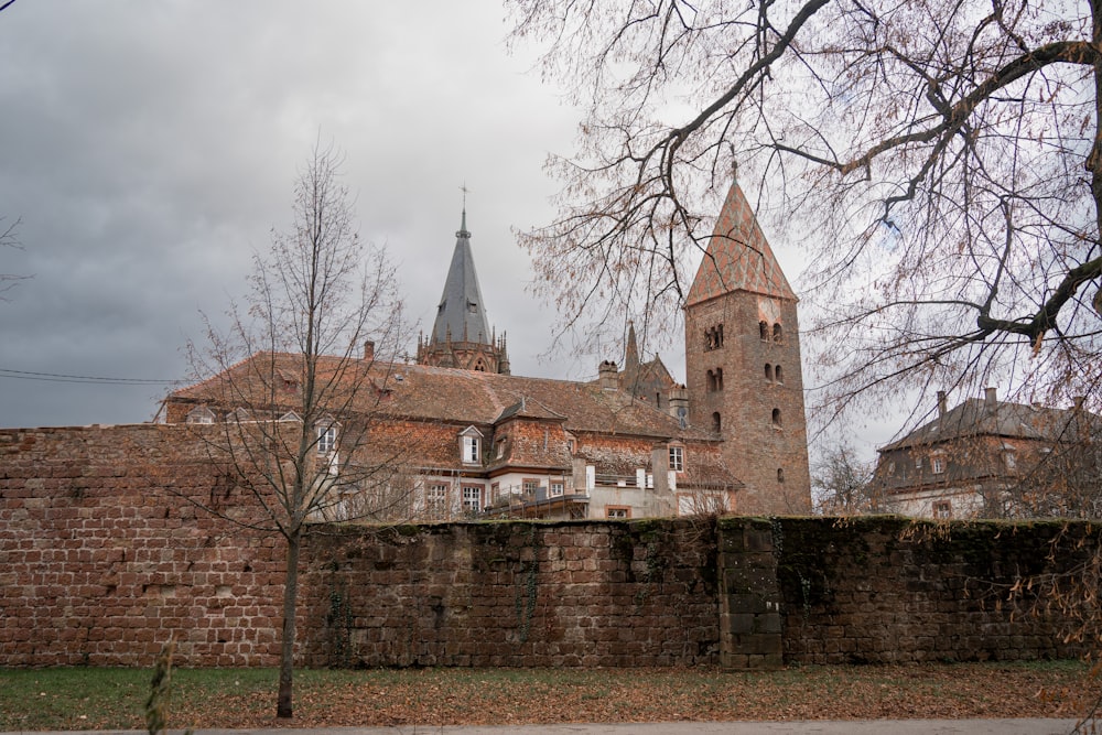 a large brick building with a steeple in the background