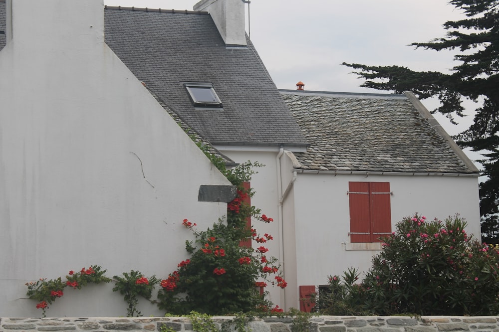 a white house with a red door and window