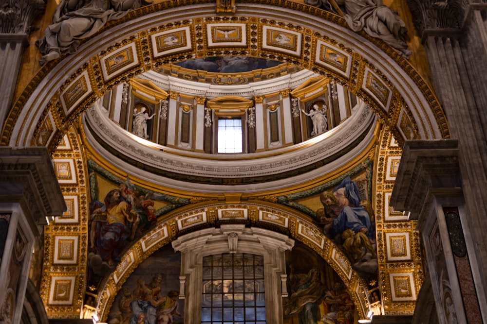 a large ornate building with paintings on the walls