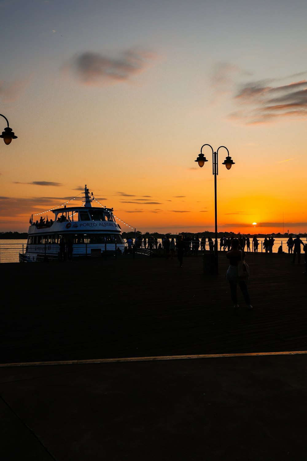 a group of people standing on top of a pier