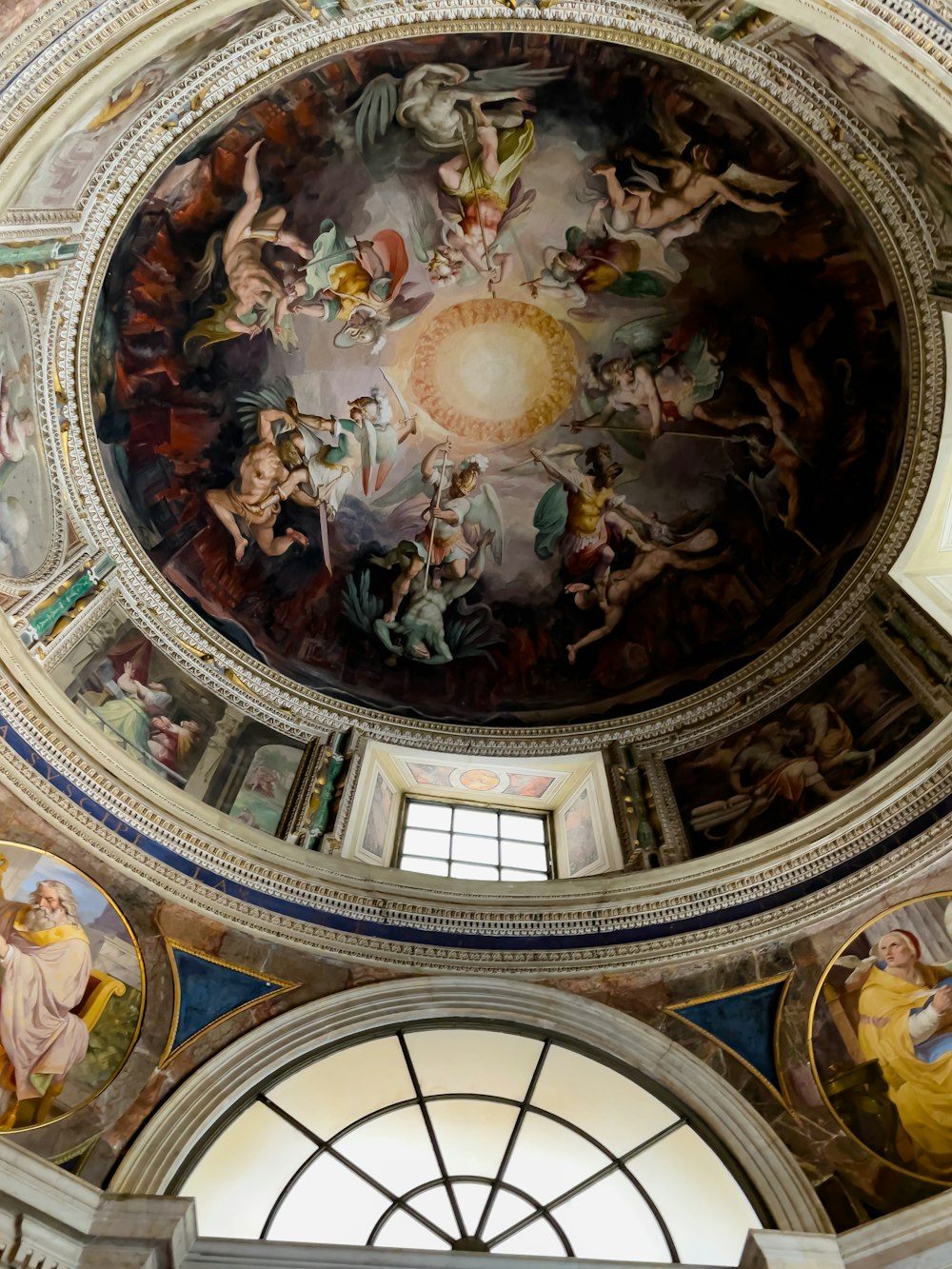 the ceiling of a building with paintings on it