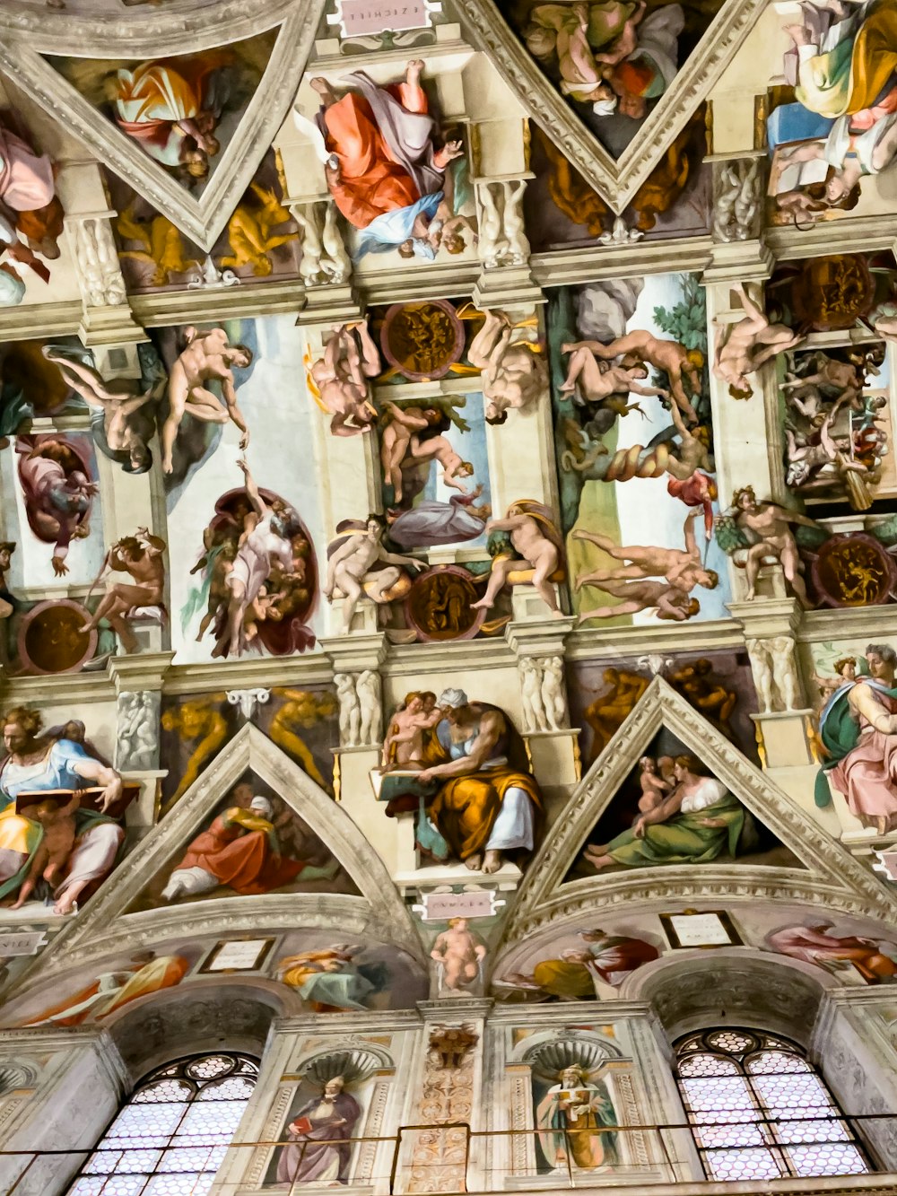 the ceiling of a building with many paintings on it