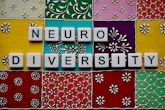 the word neuro university spelled with scrabble tiles