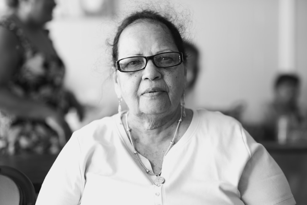 a black and white photo of a woman with glasses