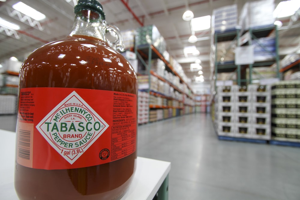 a bottle of tabasco sitting on a shelf in a store