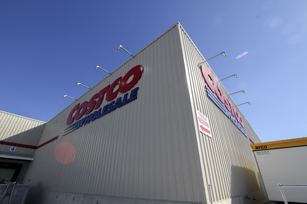 a large white building with a red and blue sign on it