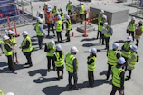 a group of construction workers standing around each other