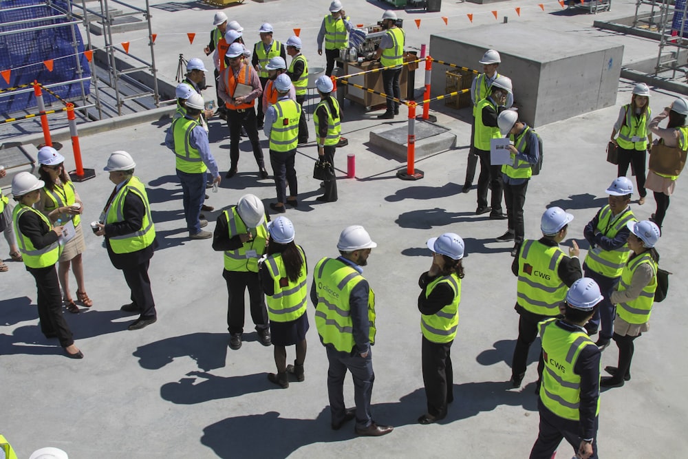 a group of construction workers standing around each other