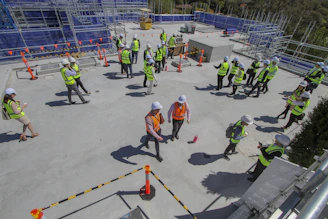 a group of construction workers standing on top of a building
