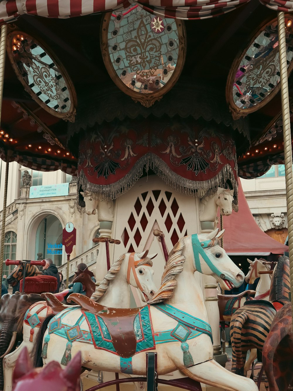 a merry go round with horses on a city street