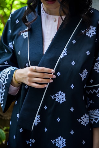 a woman wearing a black and white kimono