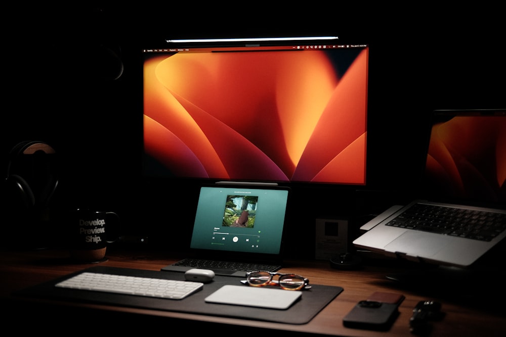 a laptop computer sitting on top of a wooden desk