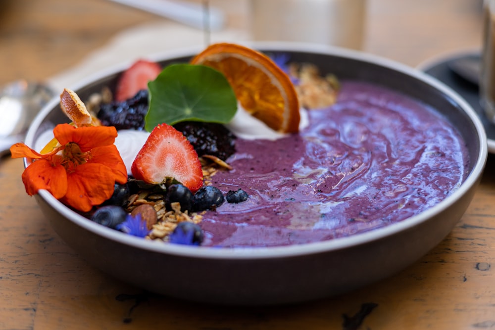 a bowl of fruit and yogurt on a table