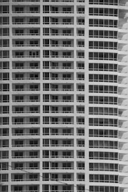a  photo of a tall building painted white