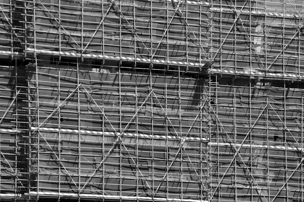 a black and white photo of scaffolding on a building