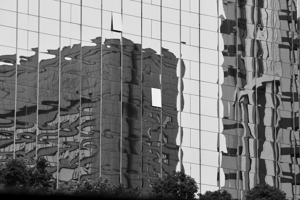 the reflection of a building in the windows of another building