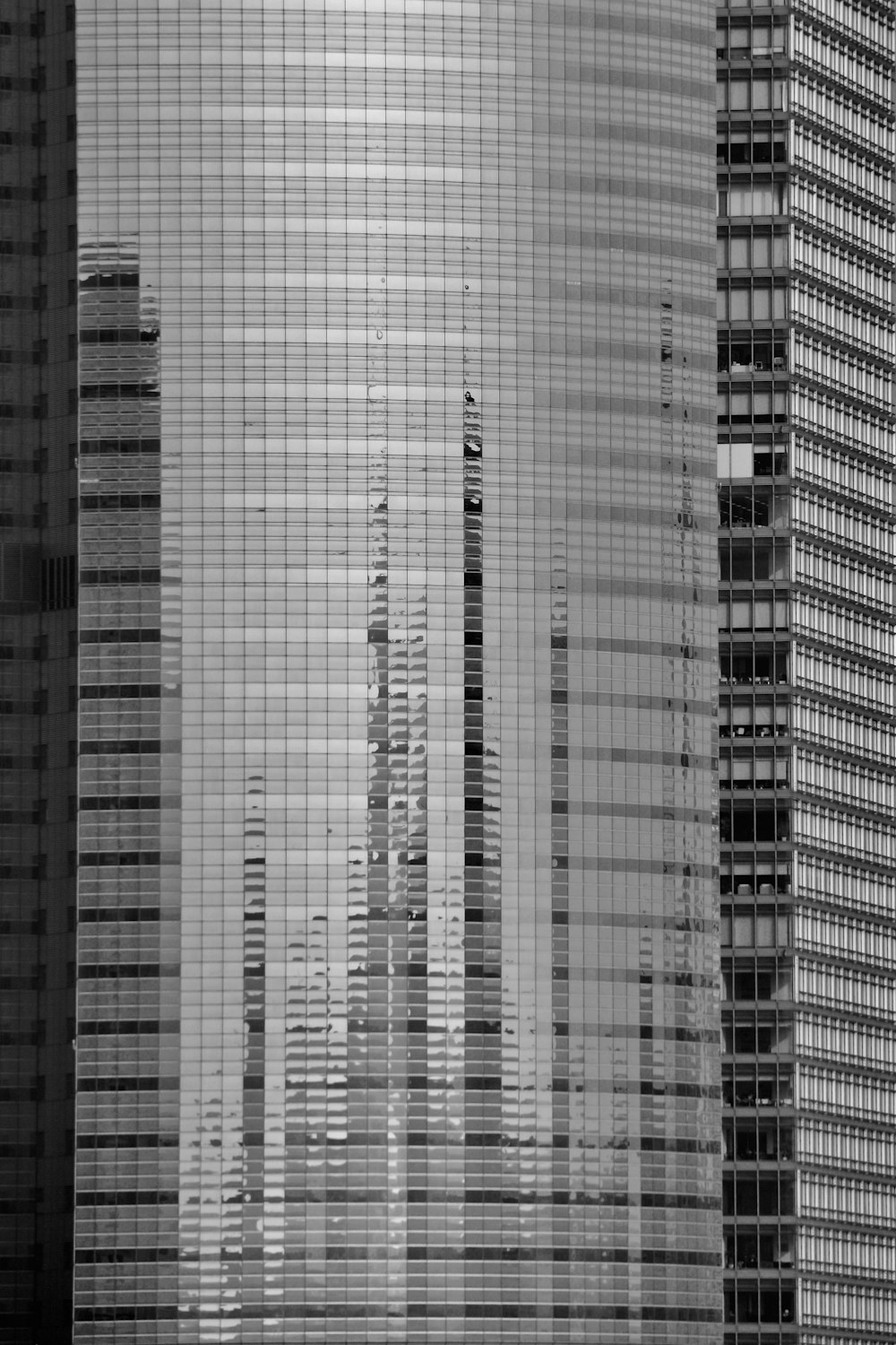 a black and white photo of tall buildings