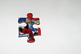 A designer sketching colorful puzzle pieces on a drawing pad.